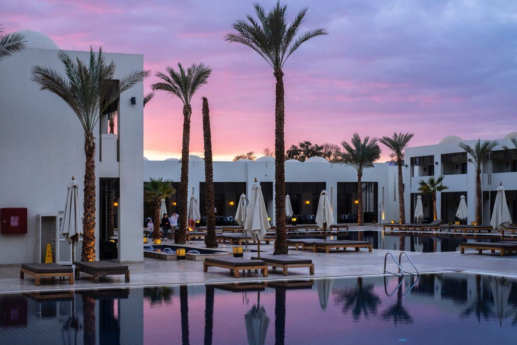 Hotel with pool at sunset